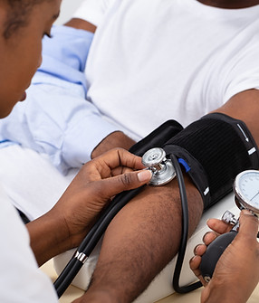Nurse taking blood pressure of patient